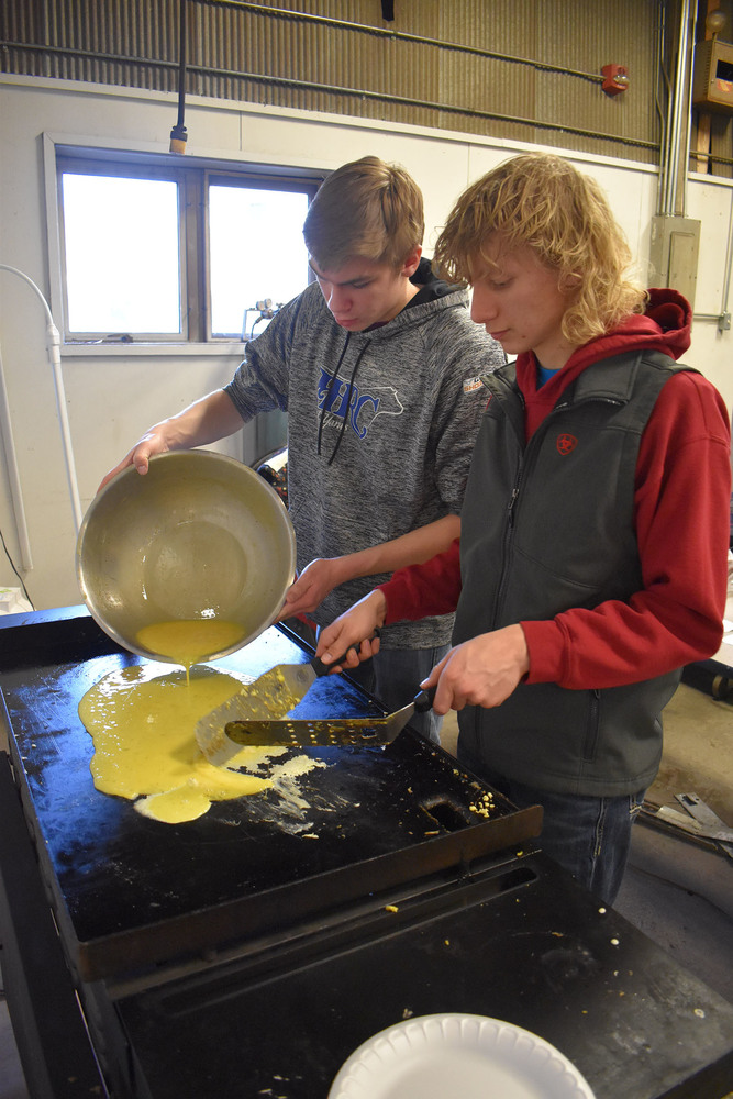 Hudson and Dustin making eggs.
