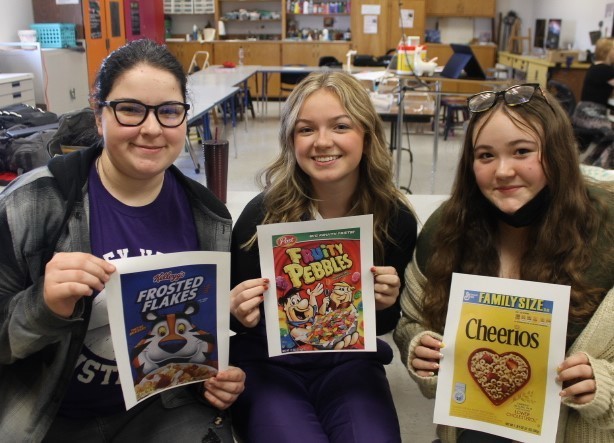 Kendelle Sweet (left), Khloe Gunn (middle), and Savannah Daye (right) holding up their favorite cereals. 