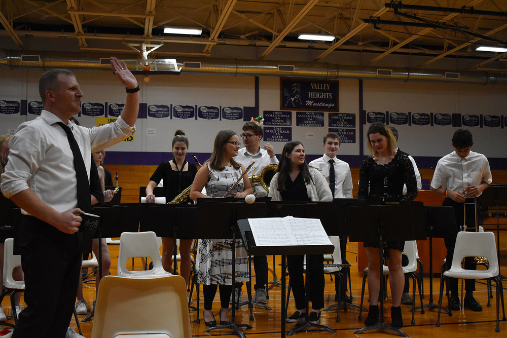 Mr. Worcester and band kids smiling after their first concert.