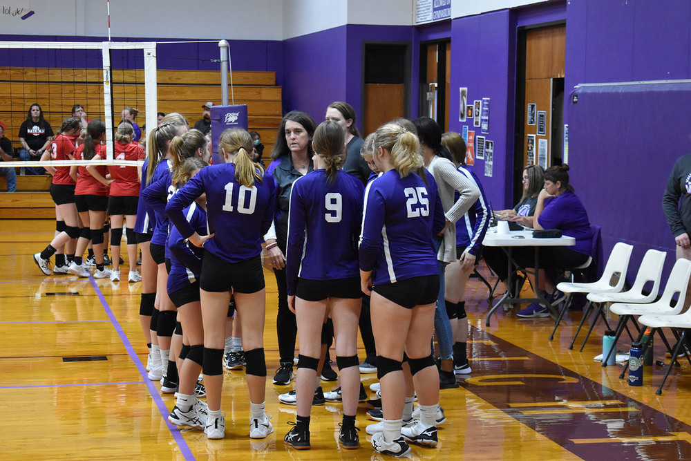 jh volleyball team in huddle