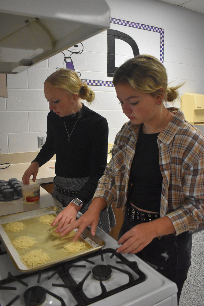 Khloe Gunn and Haily Stoudt preparing meal for culinary service